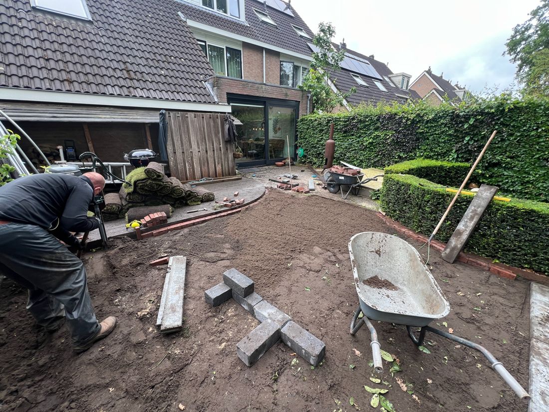 Twee teamleden aan het werk bij de aanleg van een tuin